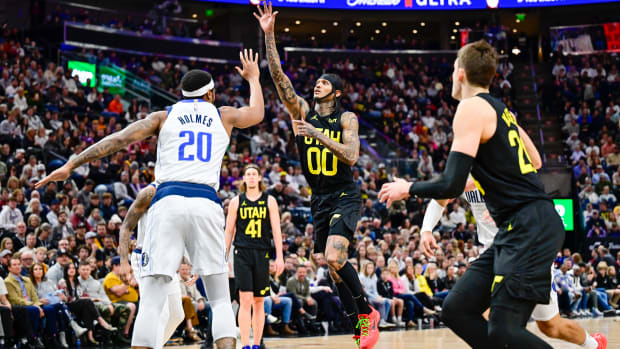 Jan 1, 2024; Salt Lake City, Utah, USA; Utah Jazz guard Jordan Clarkson (00) takes a shot over Dallas Mavericks forward Richaun Holmes (20) during the second half at the Delta Center. Mandatory Credit: Christopher Creveling-USA TODAY Sports